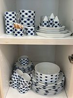 Cabinet view showing majority of dinner service pieces
