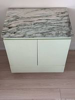 Front view of side table with marble top attached
