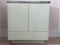front view of side table showing cabinet doors and drawer