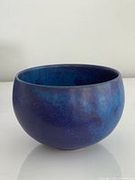 Side profile of ceramic bowl showing rounded form and exterior glaze