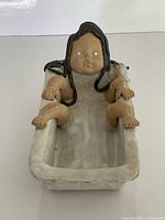 Full front view of stoneware girl in bathtub