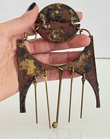 Pendant front view showing overall design and patina