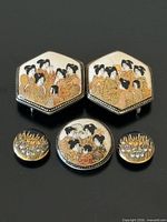Front view of all five porcelain pieces showing painted motifs