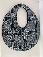 Full view of tote bag front showing swirl pattern and shape