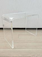 Full front view of clear lucite waterfall bench