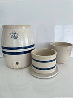 Three stoneware pieces: Blue Crown crock, blue-band planter, beige scalloped planter