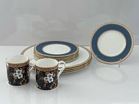 Overall lot: stacked plates, two mugs, separate display plate