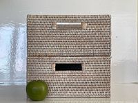 Two baskets stacked with apple for scale