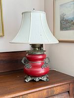 Full view of converted Liberty oil lamp with shade on wooden surface
