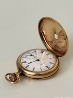 Open hunter case pocket watch showing dial, hole in crystal and front cover