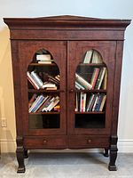 Full front view of cabinet showing glass doors, shelves, drawer and dimensions context