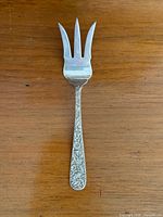 Full view of fork front showing three tines and patterned handle