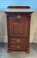 Front view of solid wood secretary desk cabinet with brass hardware