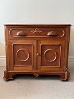 Front view showing overall design, drawer, doors, feet