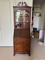 Full view of secretary desk showing cabinet, drop-front desk, drawers, overall form