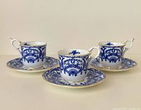 Three teacups with matching saucers displayed
