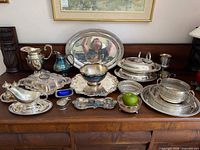 Overall view of all silver-plated items arranged on sideboard