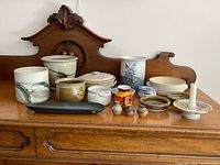 Full group of pottery pieces on dresser