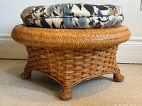 Side view of rattan ottoman showing weave pattern, cushion on top