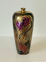 Front view of vase showing metallic gold finish and purple floral design