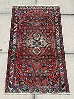 Full view of red Persian rug showing overall pattern