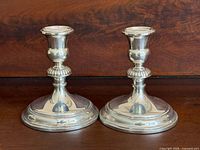 Front view of both Birks sterling silver candlesticks