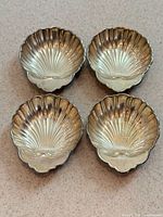 Top view of four Birks sterling silver shell dishes