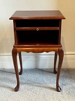 Front view showing open compartment, brass knob front, cabriole legs, overall wear