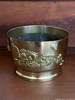 Full view of brass jardiniere showing dragon relief and pedestal base