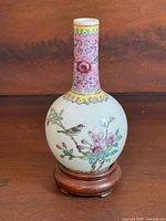 Full view of vase on wooden stand