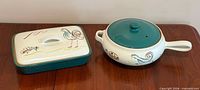 Rectangular and round Denby Flair covered casseroles side by side on table