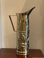 Full side view of entire brass pitcher