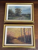 Both framed landscape paintings shown together
