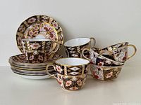 Group of seven cups and saucers stacked and displayed