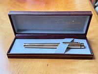 Pen inside open burgundy Sheaffer case