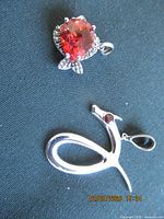 Both pendants front view showing designs and stones