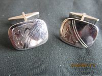 Front view showing etched designs on both cufflinks