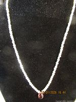 Full view of pearl necklace showing strand and pendant