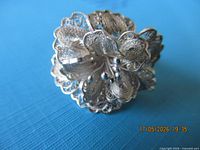 front view showing detailed filigree flower design