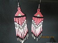 Full view of both earrings hanging to show overall design and length