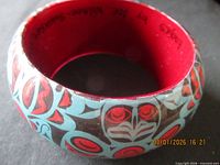 Side view showing eagle motif pattern and signature placement