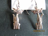 front view of both cat earrings showing design details