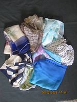 Group of eight scarves arranged in circle showing variety of colors and patterns
