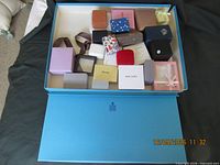 Overview showing open large Birks box with assorted smaller boxes inside, lid beside