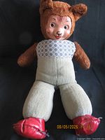 Full view of brown plush bear doll showing entire body and red shoes