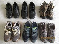 Six pairs of men’s shoes and boots laid out