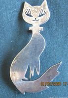 Full front view of sterling silver cat brooch showing overall design and size