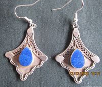 Front view of both sterling silver earrings with blue stones