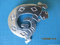 Front view of sterling silver lizard brooch showing design details