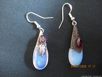 Both mismatched earrings front view